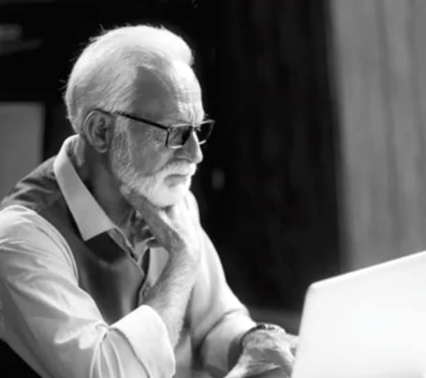 Fred reading on laptop Fred focused on his laptop and reading